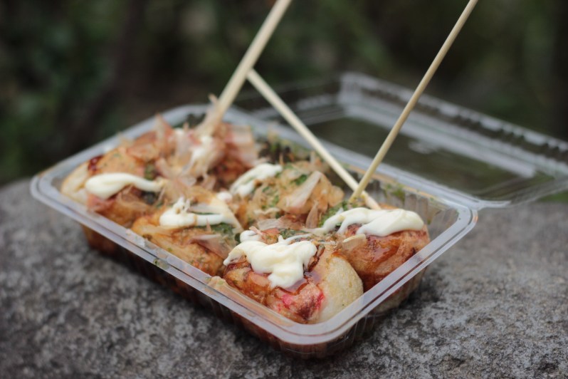 Takoyaki - octopus ball in a slightly sweet, slightly gooey batter, topped with mayonnaise, seaweed, fish flakes (dried bonito) and takoyaki sauce (brown, sweet and similar to Worcestershire sauce)